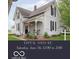 Charming two-story house with a cozy front porch and an American flag, surrounded by a well-manicured lawn at 47 Meadow Dr, New Palestine, IN 46163
