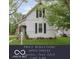 Charming two-story home with black shutters, landscaped yard, and an American flag by the front door at 47 Meadow Dr, New Palestine, IN 46163