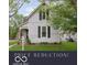 Charming two-story home with traditional architecture, black shutters, and a inviting front porch at 47 Meadow Dr, New Palestine, IN 46163