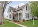 Two-story home featuring a welcoming front porch with decorative trim and an American flag displayed at 47 Meadow Dr, New Palestine, IN 46163