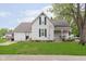 Charming two-story home with well-maintained front lawn, porch, and an American flag at 47 Meadow Dr, New Palestine, IN 46163
