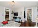 Cozy living room with hardwood floors, modern decor, and doorways leading to other rooms at 47 Meadow Dr, New Palestine, IN 46163