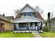 Charming two-story home with a front porch, white siding, and a well-manicured front lawn at 3634 N Kenwood Ave, Indianapolis, IN 46208