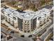 Modern multi-story apartment building with balconies and rooftop HVAC units stands at a street corner at 1155 S Rangeline Rd # 501, Carmel, IN 46032