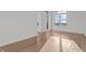 Bright bedroom with hardwood floors, large windows and doors, offering ample natural light and views at 1155 S Rangeline Rd # 501, Carmel, IN 46032