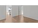 Bright bedroom with hardwood floors leading to an open-concept kitchen and dining area at 1155 S Rangeline Rd # 501, Carmel, IN 46032