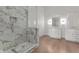 Modern bathroom featuring a glass enclosed shower with marble tiling and dual vanity sinks at 1155 S Rangeline Rd # 506, Carmel, IN 46032