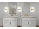 Elegant bathroom with dual sinks, gold-framed mirrors, and modern lighting fixtures at 1155 S Rangeline Rd # 506, Carmel, IN 46032