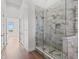 Contemporary bathroom with a sleek glass shower enclosure and neutral marble tile at 1155 S Rangeline Rd # 506, Carmel, IN 46032