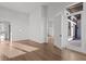 Bright bedroom with hardwood floors, a doorway to a patio, and ample natural light at 1155 S Rangeline Rd # 506, Carmel, IN 46032