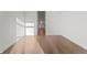 Minimalist bedroom with light wood floors, white walls and a glimpse into an ensuite bathroom at 1155 S Rangeline Rd # 506, Carmel, IN 46032