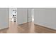 Light-filled bedroom showcasing hardwood floors and a doorway leading to the kitchen at 1155 S Rangeline Rd # 506, Carmel, IN 46032