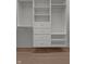 Organized walk-in closet with built-in drawers and shelving units to maximize storage at 1155 S Rangeline Rd # 506, Carmel, IN 46032