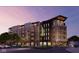 Modern apartment building showcasing stylish architectural design, balconies, and street-level retail spaces at 1155 S Rangeline Rd # 506, Carmel, IN 46032
