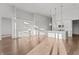 Bright open-concept kitchen featuring white cabinets, island with sink, and stainless steel appliances at 1155 S Rangeline Rd # 506, Carmel, IN 46032