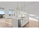 Open living space featuring a kitchen with a large island and modern lighting at 1155 S Rangeline Rd # 506, Carmel, IN 46032