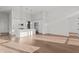 Open-concept kitchen featuring white cabinets, a large island, and modern stainless steel appliances at 1155 S Rangeline Rd # 506, Carmel, IN 46032
