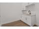 Modern kitchenette with white cabinets and white countertops at 1155 S Rangeline Rd # 506, Carmel, IN 46032