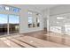 Bright open living room with large windows, white cabinets, and hardwood floors at 1155 S Rangeline Rd # 506, Carmel, IN 46032