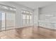 Spacious living room with large windows and an adjacent modern kitchen with white cabinets at 1155 S Rangeline Rd # 506, Carmel, IN 46032