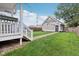Spacious backyard features lush green grass and a detached garage with a private setting at 2434 N Pennsylvania St, Indianapolis, IN 46205