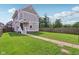 Inviting backyard featuring lush lawn, privacy fence, and charming two-story home at 2434 N Pennsylvania St, Indianapolis, IN 46205
