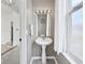 Compact bathroom featuring pedestal sink, neutral paint and decor, with great natural light at 2434 N Pennsylvania St, Indianapolis, IN 46205