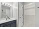 Bathroom vanity with a white countertop, framed mirror and a walk-in closet at 2434 N Pennsylvania St, Indianapolis, IN 46205
