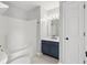 Bathroom with a tub shower and a vanity with navy blue cabinets at 2434 N Pennsylvania St, Indianapolis, IN 46205