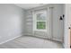 Light-filled bedroom features a window, light-grey walls, shelves, plush carpet, and modern decor at 2434 N Pennsylvania St, Indianapolis, IN 46205