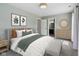 Stylized bedroom with an ensuite, neutral carpet, and light green walls at 2434 N Pennsylvania St, Indianapolis, IN 46205