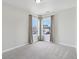 Bright bedroom featuring neutral carpet and a corner window view at 2434 N Pennsylvania St, Indianapolis, IN 46205