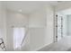 Bright hallway features neutral carpet and a curtained window at the top of the stairs at 2434 N Pennsylvania St, Indianapolis, IN 46205