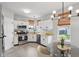 Well-lit kitchen with modern stainless steel appliances, white cabinetry, and an adjacent dining area at 2434 N Pennsylvania St, Indianapolis, IN 46205