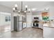 Bright kitchen with stainless steel appliances, white cabinets, and a modern light fixture at 2434 N Pennsylvania St, Indianapolis, IN 46205