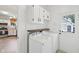 Laundry room featuring white cabinets, a wood shelf, and included washer and dryer at 2434 N Pennsylvania St, Indianapolis, IN 46205