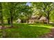 The backyard features a lush lawn, mature trees, and a patio area, perfect for relaxation and entertaining at 725 Sugarbush Dr, Zionsville, IN 46077