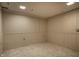Unfinished basement space with tiled floors, white paneled walls, and utility connections at 725 Sugarbush Dr, Zionsville, IN 46077