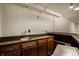 Basement bar area featuring wooden cabinets, countertops, and a stainless steel sink at 725 Sugarbush Dr, Zionsville, IN 46077