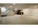 Spacious carpeted basement area with a staircase and custom bar area at 725 Sugarbush Dr, Zionsville, IN 46077