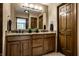 Bathroom featuring double sink vanity, granite counters, and warm lighting at 725 Sugarbush Dr, Zionsville, IN 46077
