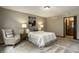 Bright bedroom featuring a seating area, carpet, and en suite bathroom access at 725 Sugarbush Dr, Zionsville, IN 46077