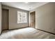 Bright bedroom with carpet, a window, and a paneled wooden door at 725 Sugarbush Dr, Zionsville, IN 46077