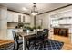 Dining room features a wood table, a black and white rug, and a view into the kitchen at 725 Sugarbush Dr, Zionsville, IN 46077