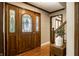 Grand foyer featuring a stunning wood door with decorative glass and a staircase with wood banister at 725 Sugarbush Dr, Zionsville, IN 46077