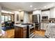 Bright open kitchen with a stainless steel refrigerator and a view into the breakfast nook at 725 Sugarbush Dr, Zionsville, IN 46077