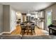 Eat-in kitchen with white cabinets, stainless steel appliances, and a dining table set at 725 Sugarbush Dr, Zionsville, IN 46077