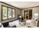 Bright living room with large windows, comfortable seating, and neutral carpet at 725 Sugarbush Dr, Zionsville, IN 46077