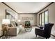 Open living room with a neutral palette, large windows, and stylish furnishings at 725 Sugarbush Dr, Zionsville, IN 46077