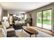Bright living room with hardwood floors, a view of the kitchen, and a sliding glass door at 725 Sugarbush Dr, Zionsville, IN 46077